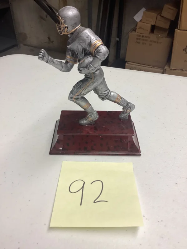 SILVER FOOTBALL RUNNER ON RED BASE