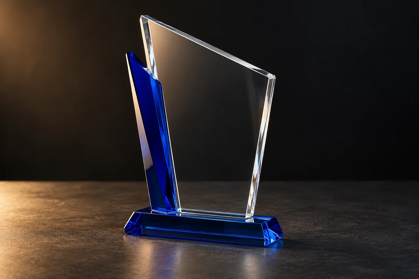 Illustration of a clear glass award with cobalt blue accents and base.