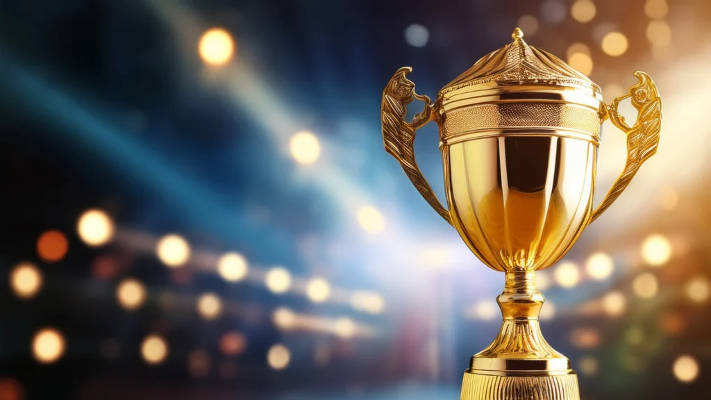 Large gold trophy against a blue and gold bokeh background